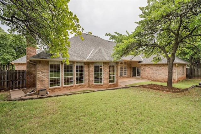 2717 Asheforde Oaks Blvd, Edmond, OK 73034 - rear view of house featuring a patio area, a chimney, roof with shingles, and brick siding