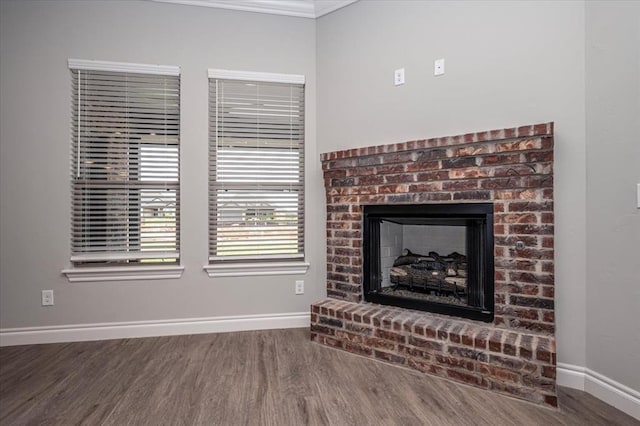 2013 W Crossbow Way, Mustang, OK 73064 - living room featuring wood finished floors, a fireplace, and ornamental molding