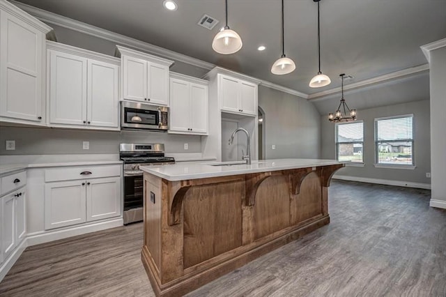 2013 W Crossbow Way, Mustang, OK 73064 - kitchen with stainless steel appliances, ornamental molding, dark wood-style floors, light countertops, and recessed lighting