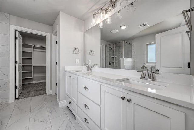 2013 W Crossbow Way, Mustang, OK 73064 - bathroom with marble look tiles, a shower stall, double vanity, and a spacious closet