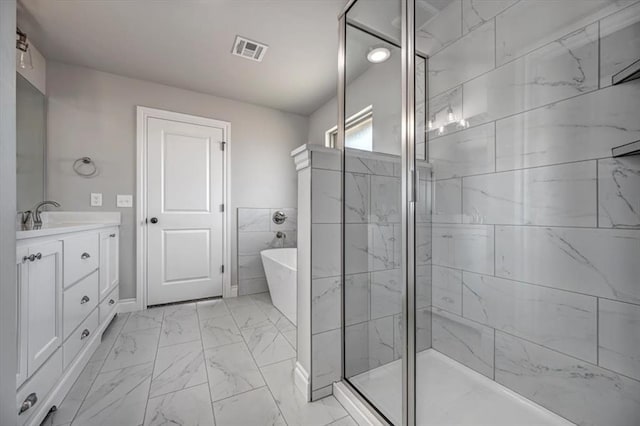 2013 W Crossbow Way, Mustang, OK 73064 - bathroom featuring marble look tile flooring, a freestanding tub, vanity, and a shower stall