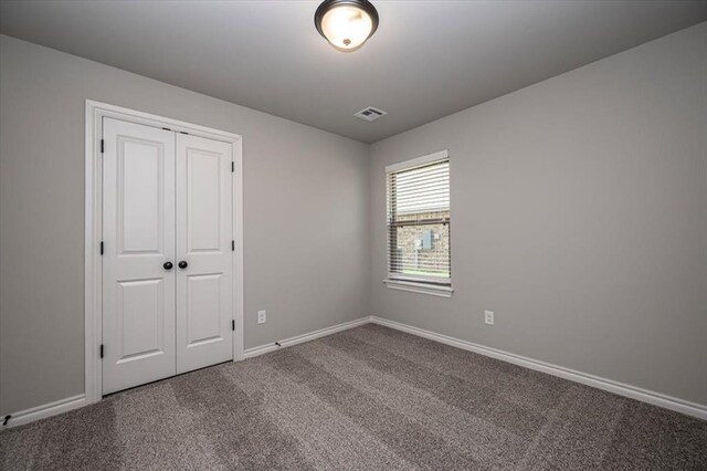 2013 W Crossbow Way, Mustang, OK 73064 - unfurnished bedroom featuring carpet floors and a closet