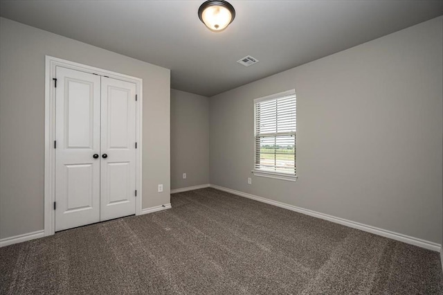 2013 W Crossbow Way, Mustang, OK 73064 - unfurnished bedroom featuring dark colored carpet and a closet
