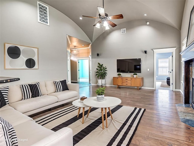 2311 Washita Trl, Edmond, OK 73003 - living area featuring a fireplace, wood finished floors, ceiling fan, high vaulted ceiling, and recessed lighting