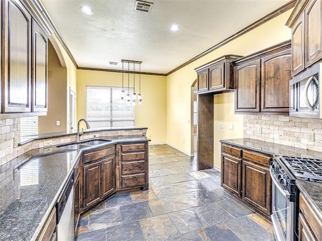 2311 Washita Trl, Edmond, OK 73003 - kitchen featuring stainless steel appliances, ornamental molding, backsplash, dark stone counters, and recessed lighting