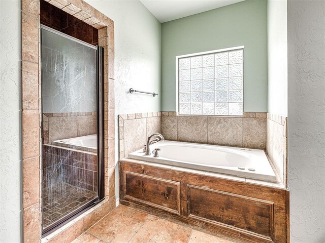 2311 Washita Trl, Edmond, OK 73003 - bathroom with a textured wall, a bath, and a shower stall