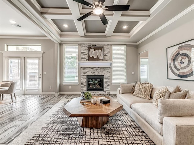 15913 Windrush Pl, Edmond, OK 73013 - living area with wood finished floors, crown molding, a fireplace, ceiling fan, and coffered ceiling