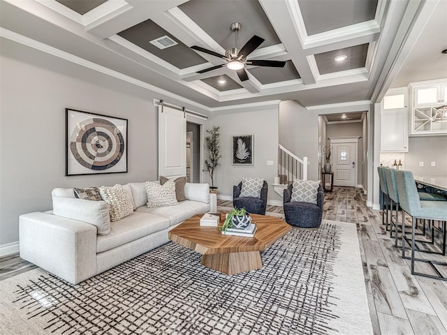 15913 Windrush Pl, Edmond, OK 73013 - living room with a barn door, coffered ceiling, stairs, light wood finished floors, and a ceiling fan