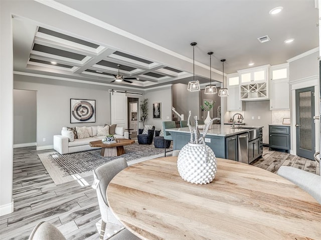 15913 Windrush Pl, Edmond, OK 73013 - dining area with light wood finished floors, coffered ceiling, crown molding, recessed lighting, and beam ceiling