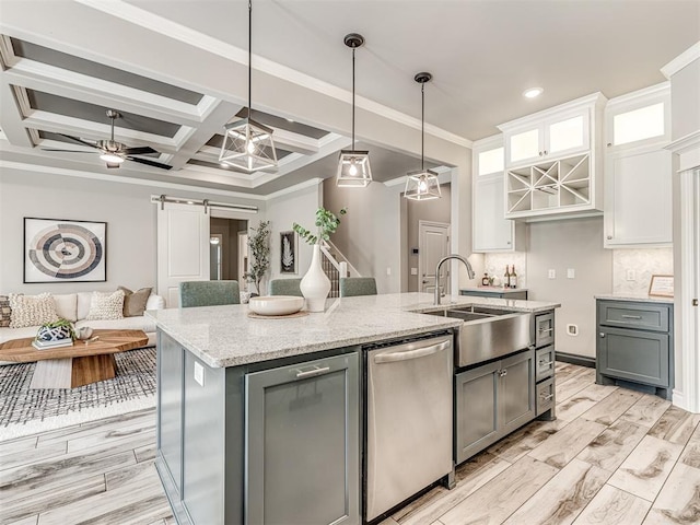 15913 Windrush Pl, Edmond, OK 73013 - kitchen featuring dishwasher, a barn door, white cabinets, a kitchen island with sink, and light stone counters