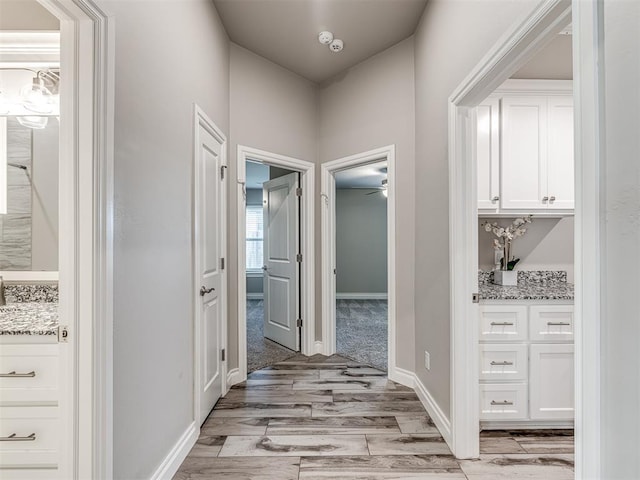 15913 Windrush Pl, Edmond, OK 73013 - hallway featuring light wood-style flooring and baseboards