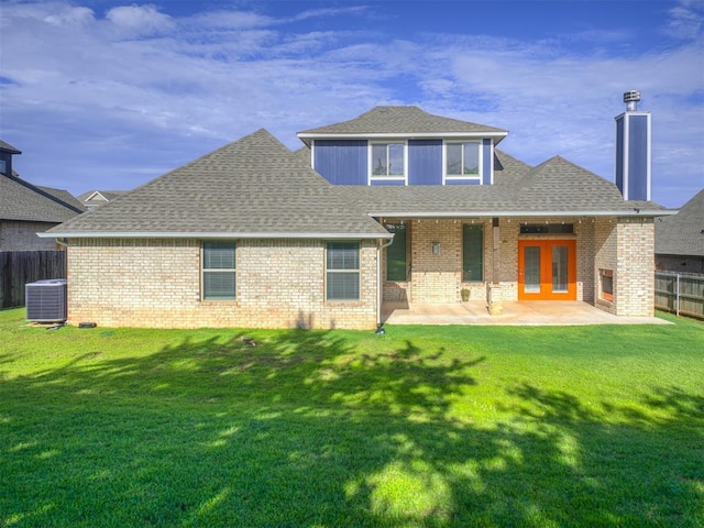 15913 Windrush Pl, Edmond, OK 73013 - rear view of house featuring a fenced backyard, roof with shingles, a patio area, and brick siding