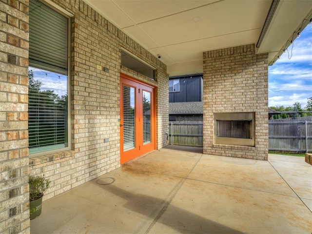 15913 Windrush Pl, Edmond, OK 73013 - view of patio with an outdoor brick fireplace