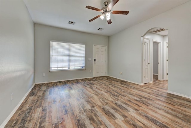 13664 NW Bradbury Ln, Piedmont, OK 73078 - unfurnished room with arched walkways, wood finished floors, and ceiling fan