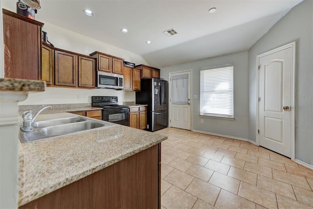 13664 NW Bradbury Ln, Piedmont, OK 73078 - kitchen with black appliances, vaulted ceiling, recessed lighting, brown cabinetry, and light tile patterned floors