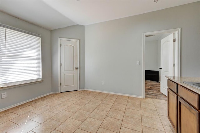 13664 NW Bradbury Ln, Piedmont, OK 73078 - empty room featuring vaulted ceiling, healthy amount of natural light, and light tile patterned floors