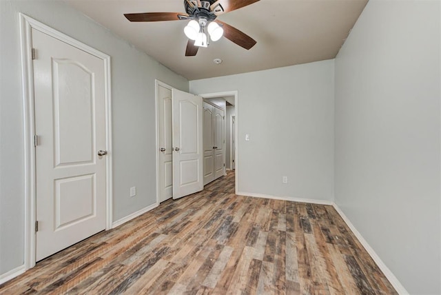 13664 NW Bradbury Ln, Piedmont, OK 73078 - unfurnished bedroom featuring wood finished floors and ceiling fan
