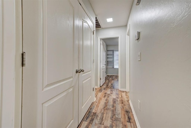 13664 NW Bradbury Ln, Piedmont, OK 73078 - hallway featuring wood finished floors and baseboards