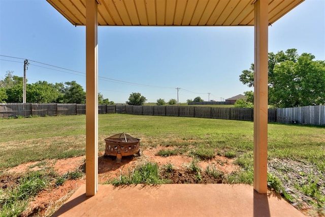 13664 NW Bradbury Ln, Piedmont, OK 73078 - fenced backyard with a patio area and an outdoor fire pit