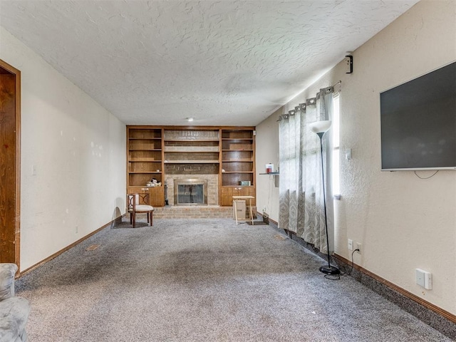 200 S Morgan Dr, Moore, OK 73160 - unfurnished living room featuring a textured ceiling, carpet, built in features, and a brick fireplace