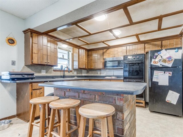 200 S Morgan Dr, Moore, OK 73160 - kitchen with freestanding refrigerator, stainless steel microwave, backsplash, and a center island