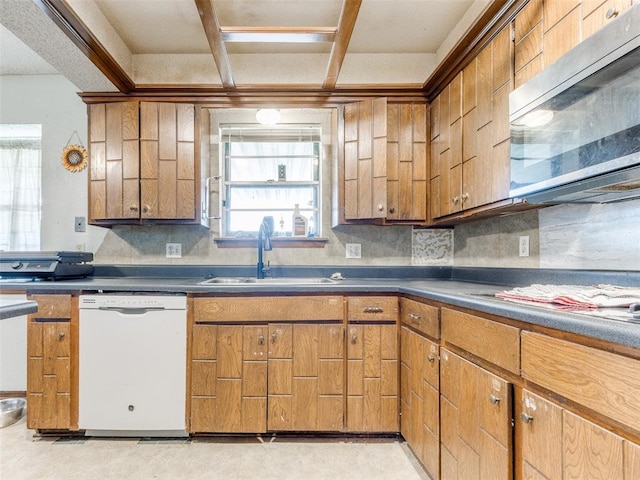 200 S Morgan Dr, Moore, OK 73160 - kitchen with white dishwasher, stainless steel microwave, decorative backsplash, brown cabinetry, and coffered ceiling