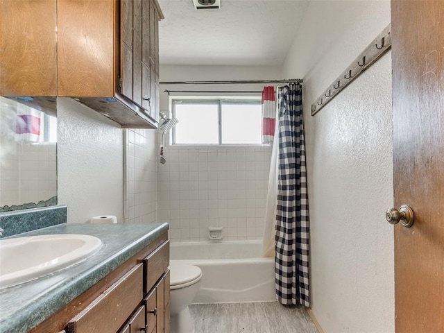 200 S Morgan Dr, Moore, OK 73160 - bathroom featuring vanity, a textured wall, wood finished floors, and shower / bath combination with curtain