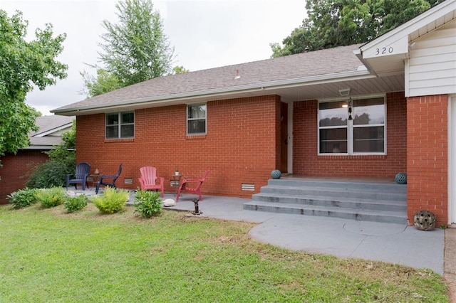 320 E 13th St, Edmond, OK 73034 - rear view of property with brick siding, a lawn, a patio, and a shingled roof