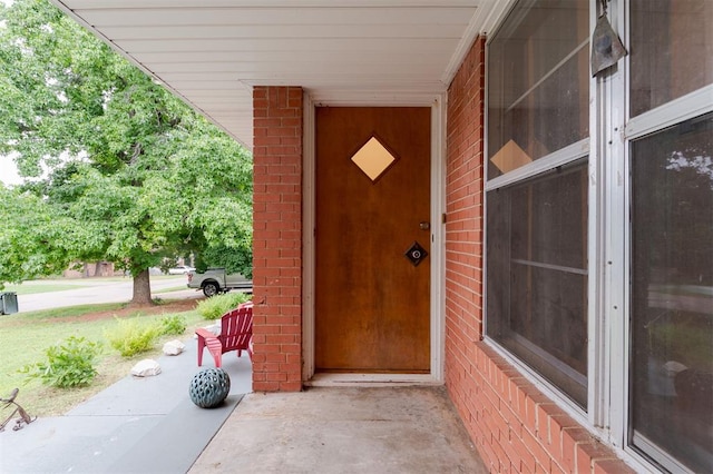 320 E 13th St, Edmond, OK 73034 - view of exterior entry featuring brick siding