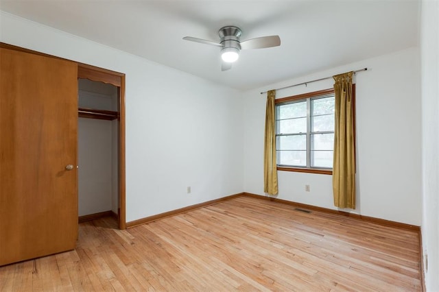 320 E 13th St, Edmond, OK 73034 - unfurnished bedroom featuring light wood-style flooring, a closet, and ceiling fan