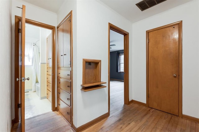 320 E 13th St, Edmond, OK 73034 - corridor with light wood-style flooring and ornamental molding