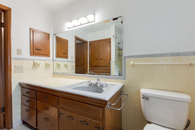 320 E 13th St, Edmond, OK 73034 - bathroom with tile walls, vanity, and a wainscoted wall