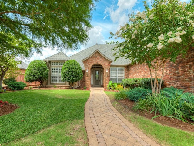 325 NW 146th St, Edmond, OK 73013 - traditional-style house featuring a front yard, brick siding, and a shingled roof