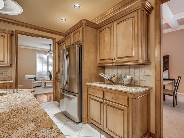 325 NW 146th St, Edmond, OK 73013 - kitchen with stainless steel refrigerator with ice dispenser, crown molding, light stone countertops, tasteful backsplash, and recessed lighting