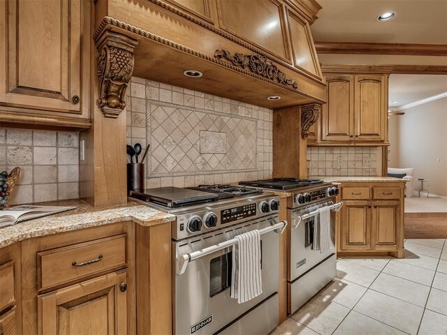 325 NW 146th St, Edmond, OK 73013 - kitchen featuring high end stainless steel range oven, crown molding, backsplash, light tile patterned flooring, and recessed lighting