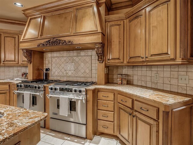 325 NW 146th St, Edmond, OK 73013 - kitchen featuring stainless steel range, premium range, light stone counters, ornamental molding, and tasteful backsplash