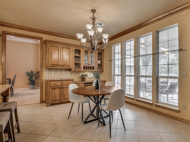 325 NW 146th St, Edmond, OK 73013 - dining room with a chandelier, light tile patterned flooring, and crown molding