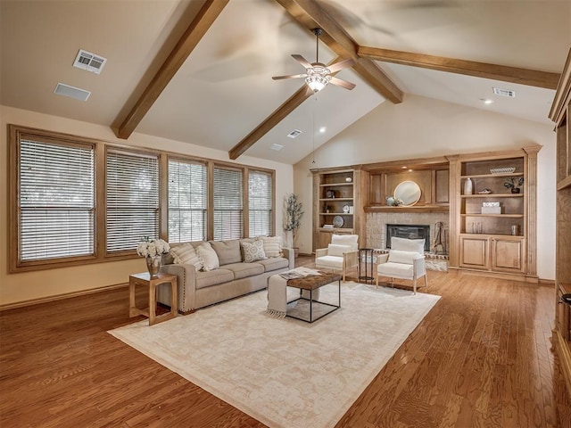 325 NW 146th St, Edmond, OK 73013 - living area featuring ceiling fan, beamed ceiling, a glass covered fireplace, light wood finished floors, and high vaulted ceiling