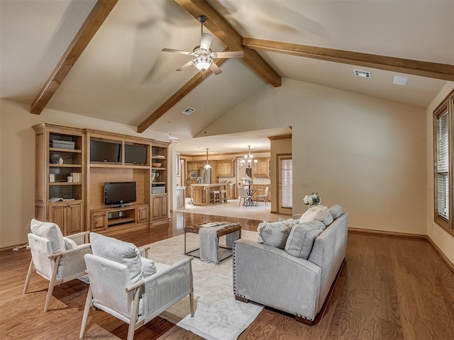 325 NW 146th St, Edmond, OK 73013 - living area with a chandelier, beam ceiling, light wood finished floors, ceiling fan, and high vaulted ceiling