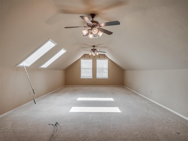 325 NW 146th St, Edmond, OK 73013 - additional living space with ceiling fan, light colored carpet, lofted ceiling, and a skylight