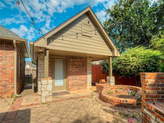 325 NW 146th St, Edmond, OK 73013 - property entrance with a patio and brick siding
