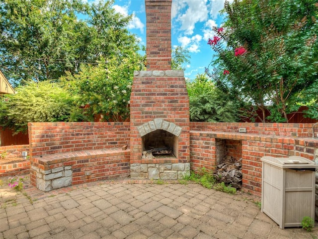325 NW 146th St, Edmond, OK 73013 - view of patio featuring an outdoor brick fireplace