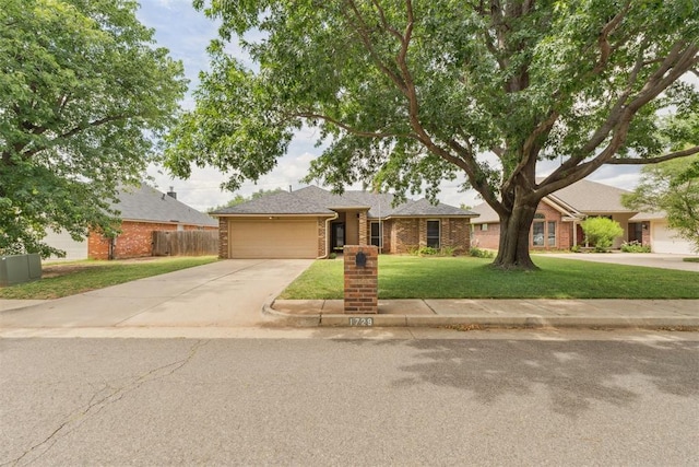 1729 Dena Dr, Edmond, OK 73003 - view of front of home featuring an attached garage, brick siding, and concrete driveway