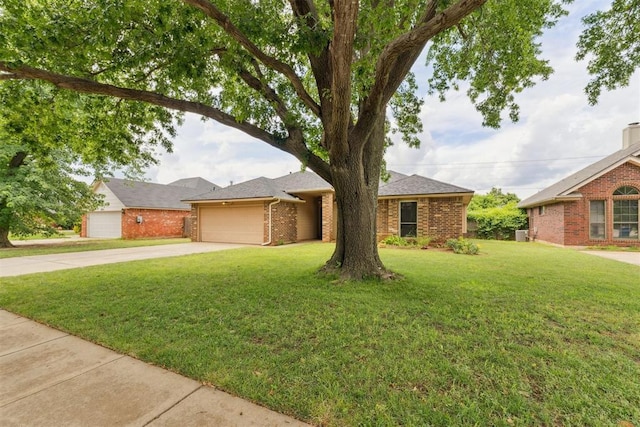 1729 Dena Dr, Edmond, OK 73003 - view of front facade featuring brick siding, driveway, an attached garage, and a front yard