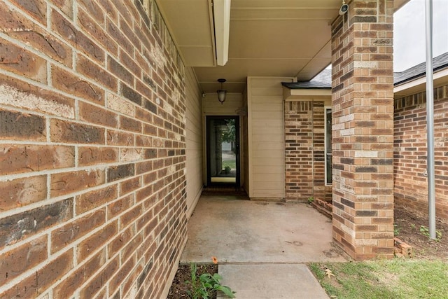 1729 Dena Dr, Edmond, OK 73003 - doorway to property featuring brick siding and a patio area