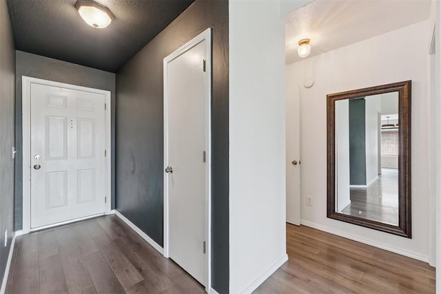 1729 Dena Dr, Edmond, OK 73003 - hall with wood finished floors and a textured ceiling