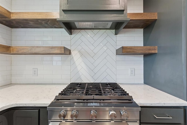 1729 Dena Dr, Edmond, OK 73003 - kitchen with gas range, decorative backsplash, ventilation hood, and light stone counters