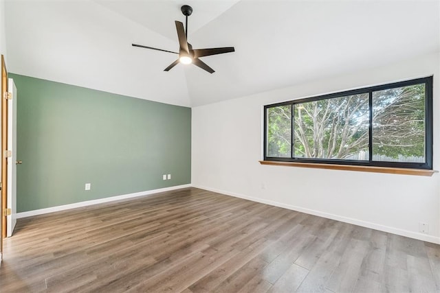 1729 Dena Dr, Edmond, OK 73003 - empty room with vaulted ceiling, a ceiling fan, and wood finished floors