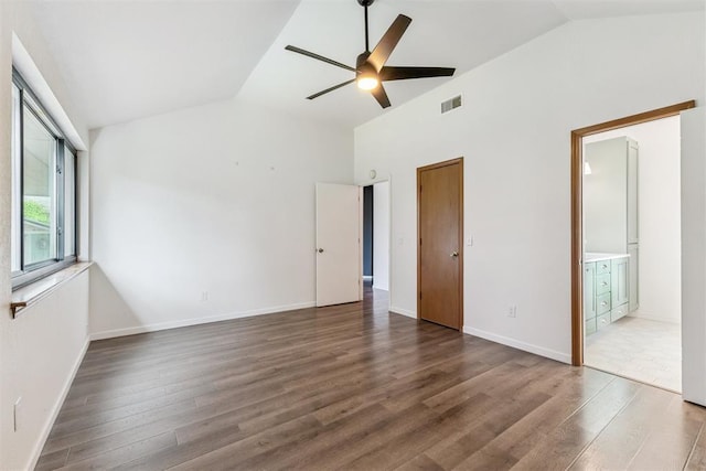 1729 Dena Dr, Edmond, OK 73003 - unfurnished bedroom featuring wood finished floors, ceiling fan, high vaulted ceiling, and ensuite bath