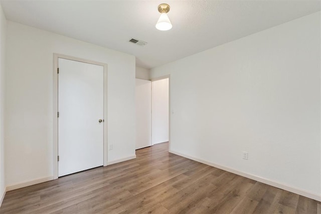 1729 Dena Dr, Edmond, OK 73003 - unfurnished bedroom featuring light wood finished floors